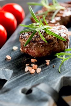 Grilled bbq steak with rosemary and tomatoes.