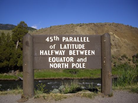 45th parallel of Latitude sign in Yellowstone Park, halfway between Equator and North Pole