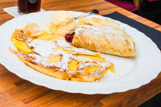 Egg pancake with apple on a plate in a restaurant