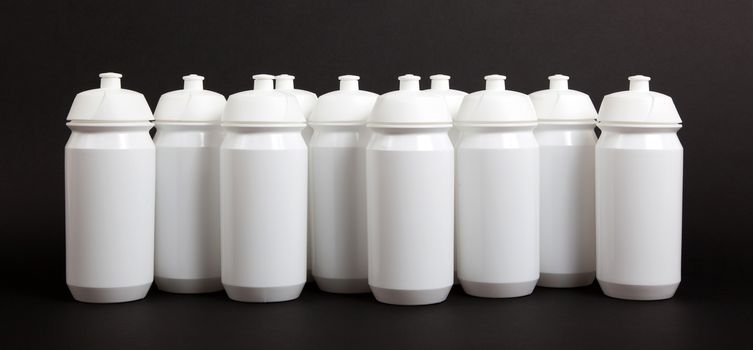 White water bottles isolated on black background