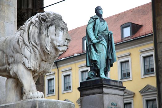 details of a stone lion sculpture and  Statue of Karl Wrede at the Odeonsplatz - Feldherrnhalle in Munich Germany