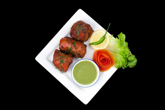 Delicious Indian tandoori chicken with salad garnishings