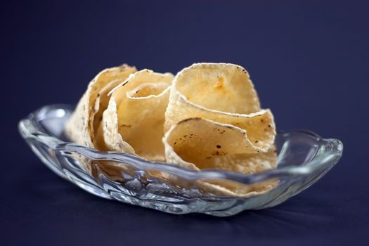 Delicious Indian Indian Papadum crisps in a glass bowl