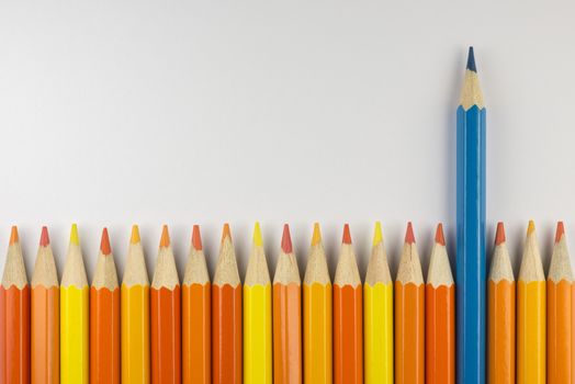 Abstract composition of a set wooden colour pencils against a white background
