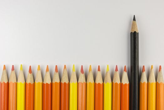 Abstract composition of a set wooden colour pencils against a white background
