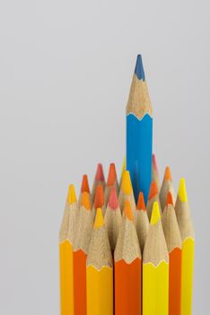 Abstract composition of a set wooden colour pencils against a white background
