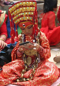 CORRECTION: Clarifies that Kumari-Puja is part of the Indra Jatra festival and not the Durga Puja festival.NEPAL, Kathmandu: A girl is prepped for the procession of Kumari Puja, as part of the Indra Jatra festival in Kathmandu, Nepal on September 26, 2015.
