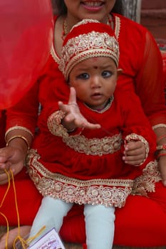 CORRECTION: Clarifies that Kumari-Puja is part of the Indra Jatra festival and not the Durga Puja festival.NEPAL, Kathmandu: A girl is prepped for the procession of Kumari Puja, as part of the Indra Jatra festival in Kathmandu, Nepal on September 26, 2015.