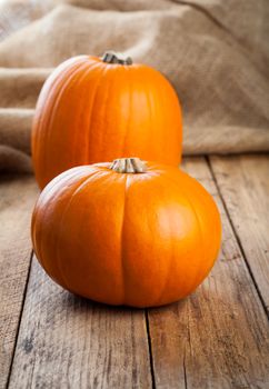 Autumn pumpkins on wooden board