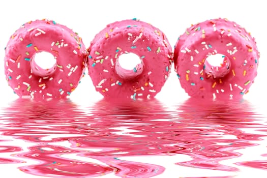 Strawberry donuts with chocolate shavings colors reflected in the water.Horizontal image.