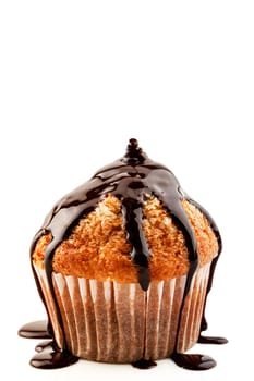 Homemade muffin with liquid chocolate on white background.Vertical image