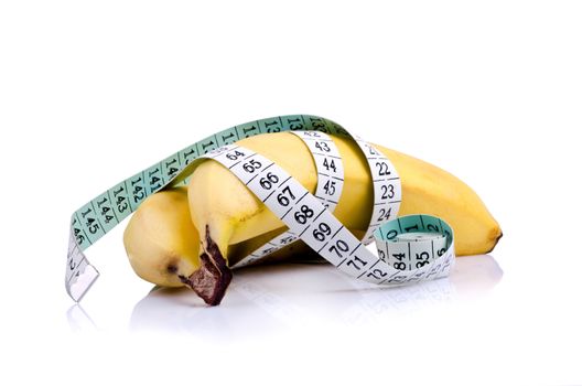 Concept of healthy lifestyle - two bananas with measuring tape.