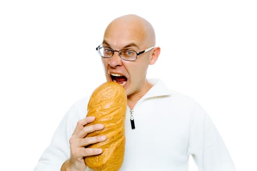 Hungry bald man with glasses bites a a large loaf. Studio. isolated