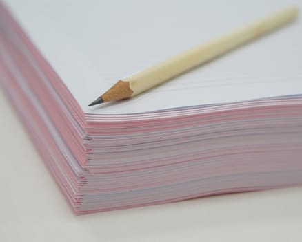 Pink document and pencil arrange on white table in office.                               