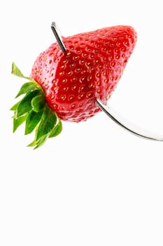 Strawberry on fork on a white background.Vertical image