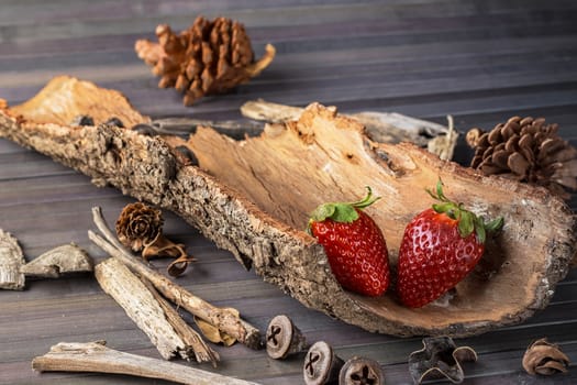 Strawberries with rustic decor in a wooden table. Horizontal image.