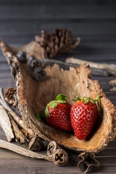 Strawberries with rustic decor in a wooden table. Vertical image.