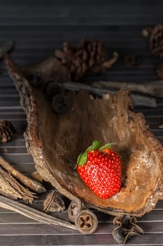Strawberry with rustic decor in a wooden table. Vertical image.