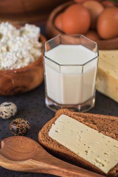 still life with dairy products as milk, cheese cottage cheese eggs and bread 