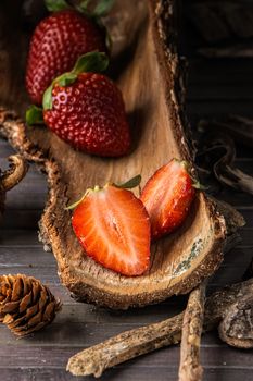 Strawberries with rustic decor in a wooden table. Vertical image.