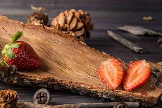Strawberries with rustic decor in a wooden table. Horizontal image.