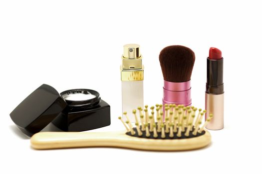 cosmetic set with parfume blusher brush lipstic and comb isolated on white background