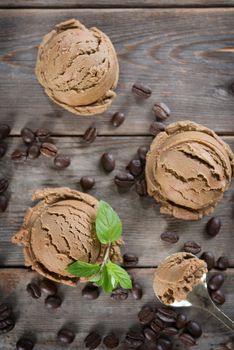 Top view brown ice cream and coffee beans on old rustic vintage wooden background. 