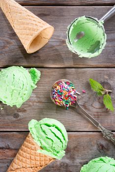 Top view matcha ice cream in a waffle cones over old rustic wooden vintage background.