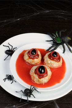 chicken meatballs in tomato gravy on the table in honor of Halloween