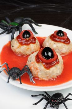  chicken meatballs in tomato gravy on the table in honor of Halloween