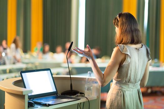 Female speaker at Business Conference and Presentation. Audience at the conference hall. Business and Entrepreneurship. Business woman. Horizontal composition.