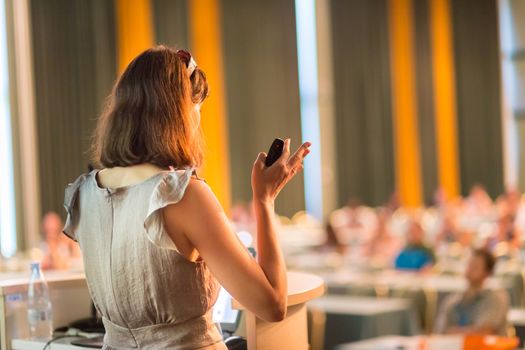 Female speaker at Business Conference and Presentation. Audience at the conference hall. Business and Entrepreneurship. Business woman. Horizontal composition.