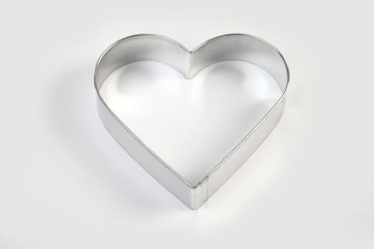 steel mold heart - shaped on white background