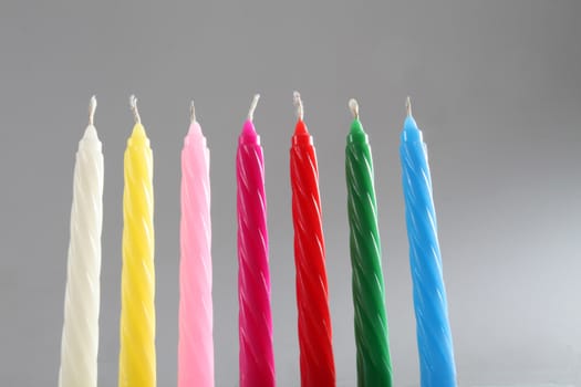 seven birthday candles on neutral background 