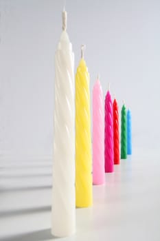 seven birthday colored candles on white background