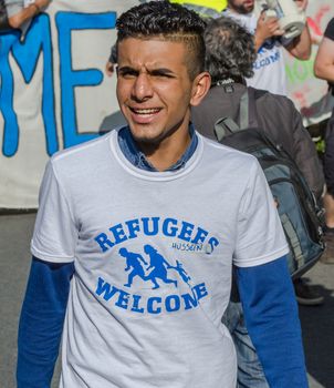 BELGIUM, Brussels: 15,000 Demonstrators carry placards, banners and t-shirts with slogans as they attend a solidarity rally for migrants and refugees in the streets of Brussels, Belgium on September 27, 2015.Demonstrators urged the Belgian government to open its gates to people escaping war torn countries.Concerns have been increasing in Europe regarding the refugee crisis as heads of the EU are urged to take steps to accept more migrants.More than 500,000 refugees have arrived in Europe already this year. 