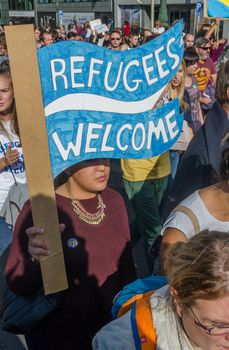 BELGIUM, Brussels: 15,000 Demonstrators carry placards, banners and t-shirts with slogans as they attend a solidarity rally for migrants and refugees in the streets of Brussels, Belgium on September 27, 2015.Demonstrators urged the Belgian government to open its gates to people escaping war torn countries.Concerns have been increasing in Europe regarding the refugee crisis as heads of the EU are urged to take steps to accept more migrants.More than 500,000 refugees have arrived in Europe already this year.