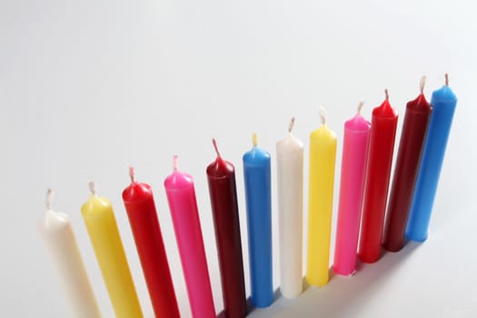 twelve cylindrical candles colorated