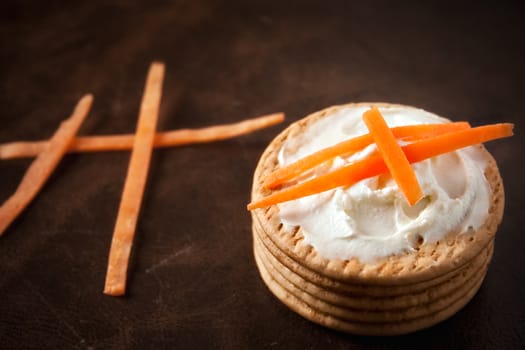 Cookies with cream cheese and strips of carrot