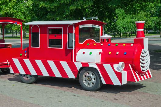 Cheerfully painted children's train for walks in the amusement park.