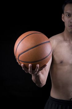 Asian young basketball player on black background