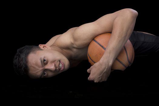 Asian young basketball player on black background