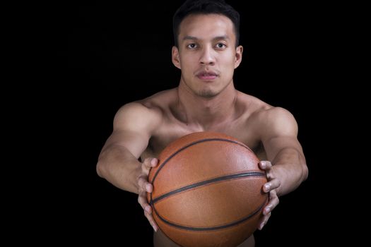 Asian young basketball player on black background