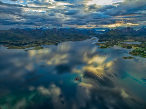 Scenic aerial view of reflecting clouds on Vesteralen islands with their dramatic mountain peaks