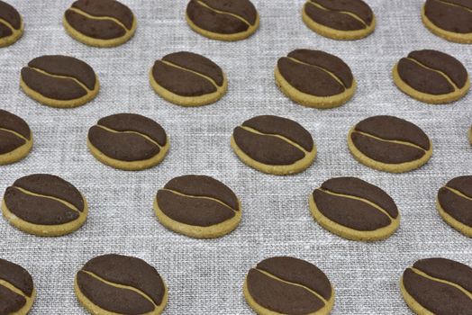 Delicious coffee cookies arranged on a tablecloth