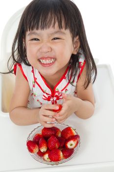 Asian Chinese children eating strawberries in plain white background.