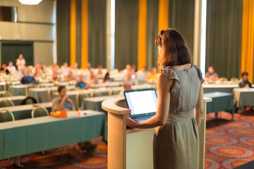 Female speaker at Business Conference and Presentation. Audience at the conference hall. Business and Entrepreneurship. Business woman. Horizontal composition.