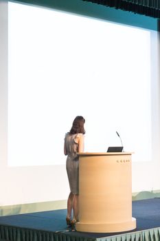 Female speaker at Business Conference and Presentation. Audience at the conference hall. Business and Entrepreneurship. Business woman. Horizontal composition.