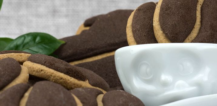 Delicious coffee cookies  in a cute cup with facial expressions