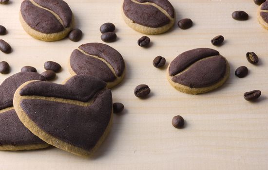 Delicious coffee cookies arranged on a wooden tray